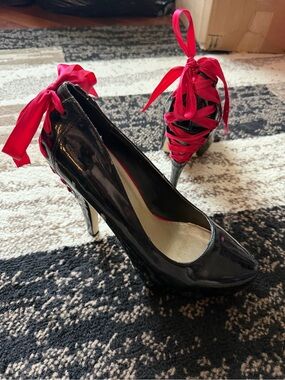 Women’s black latex like leather high heels with red ribbon corset lace tie up